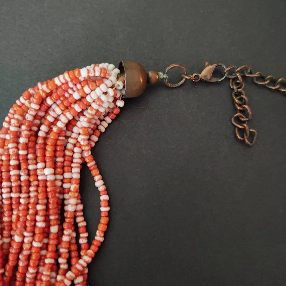 Orange and white multi strand seed bead necklace